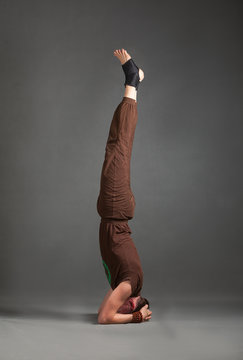 beautiful man doing yoga shirshasana