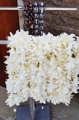 Fragrant white tuberose flower and kukui nut lei necklaces awaiting visitors in Hawaii