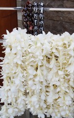 Fragrant white tuberose flower and kukui nut lei necklaces awaiting visitors in Hawaii