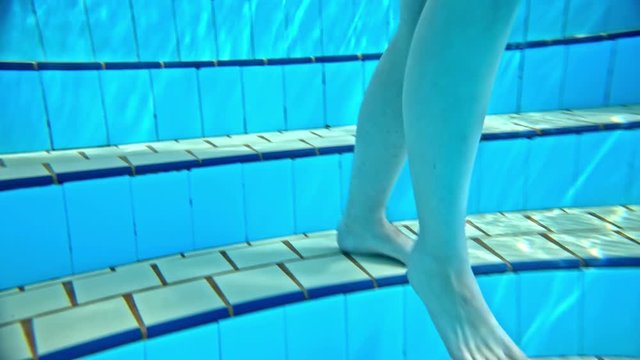 Person walk in to pool close up