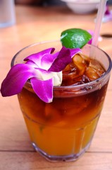 Sweet Hawaiian Mai Tai cocktail with an orchid flower
