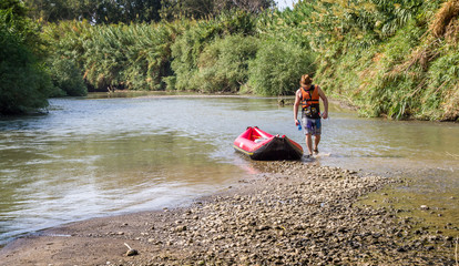 Man and boat on the Jordan River