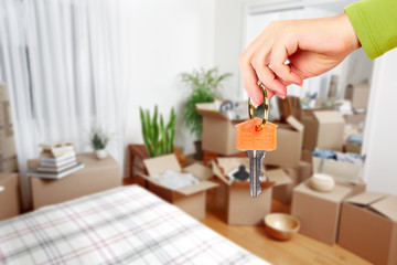 Hand with house key.