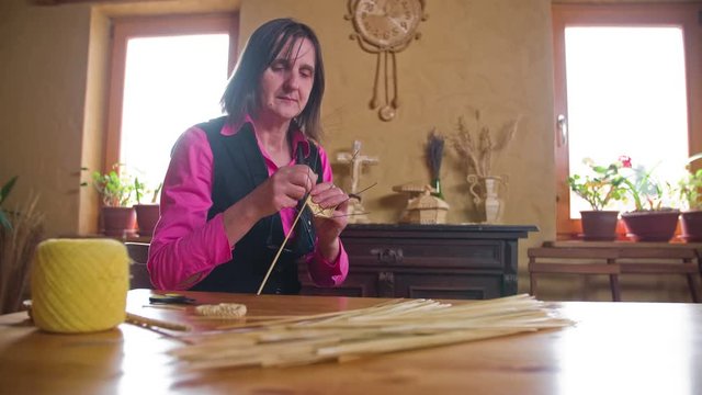 Woman crafting from dried straw