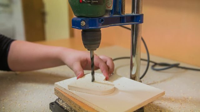 Drilling a hole in wooden heart