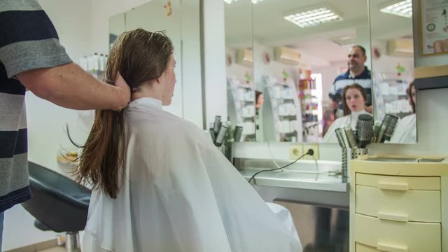 Drying long hair at salon wide shot