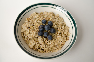 Bowl of quinoa-chia cereal with blueberry as topping