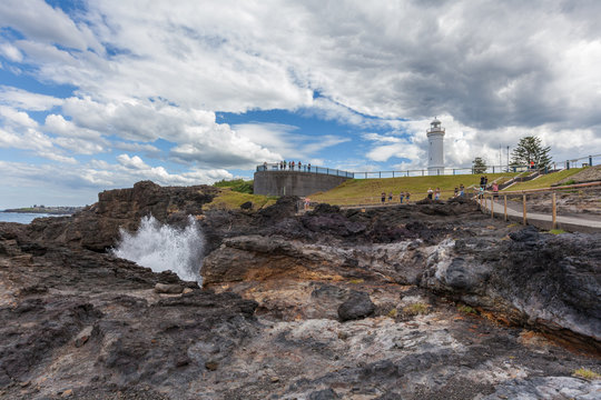 Kiama Lighthouse with water spraying out of the blowhole, Sydney, NSW, Australia