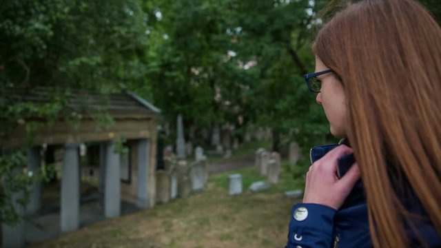 Woman stand in front of Old Jewish Cemetery in Prague