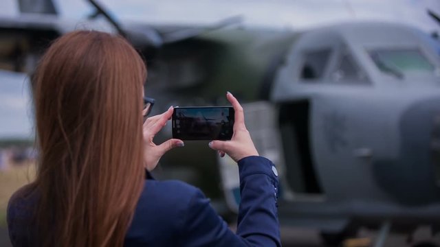 Woman take photo of bomber aircraft