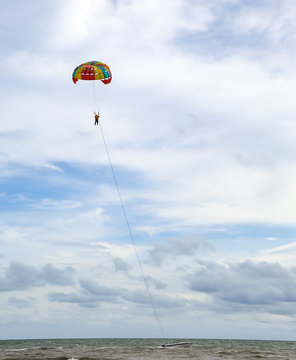 Parasailing sport on the cloud sky