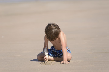 Child Drawing on Beach 