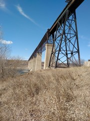 Fototapeta na wymiar Train bridge over river in spring