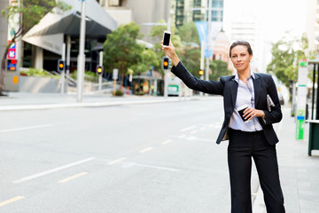 Portrait of business woman catching taxi