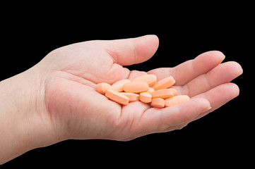 a handful of pills in hand