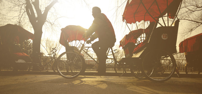 Man Riding A Rickshaw China Concept