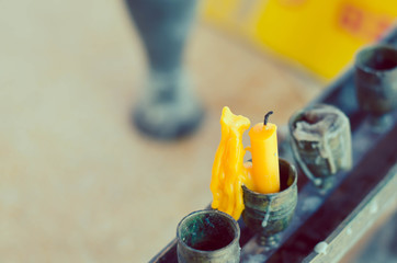 candles standing at a buddhist temple  candles are melted.
