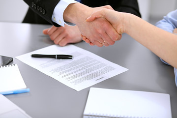 Business people shaking hands , finishing up a meeting to sign a new contract