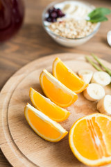 Naklejka na ściany i meble Healthy and wholesome breakfast. Sliced ​​oranges on wooden