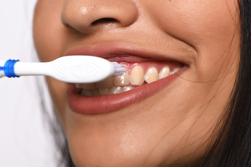 Woman brushing her teeth.