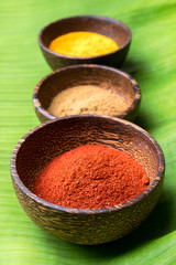 close up spicy powder in the wooden bowl on the banana leaf