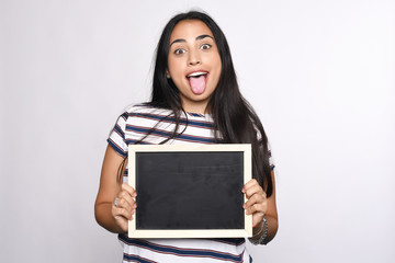 Latin woman holding chalkboard.