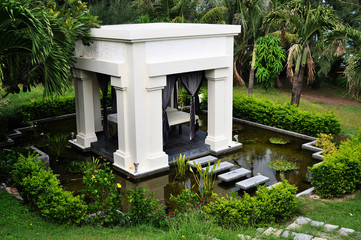 White gazebo in a tropical garden