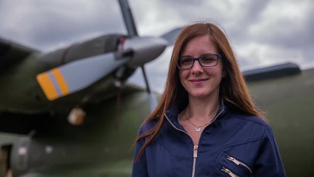 Woman pilot portrait in front of bomber plane
