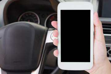 hand hold mobile phone with car steering wheel background