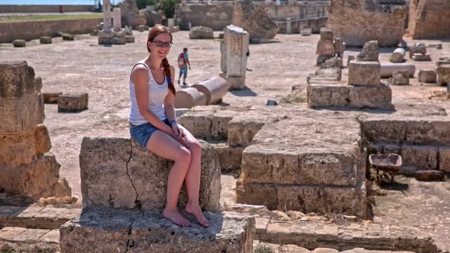 Female tourist posing on ruins of Carthage spa