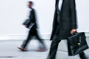 motion blurred business people walking on the street