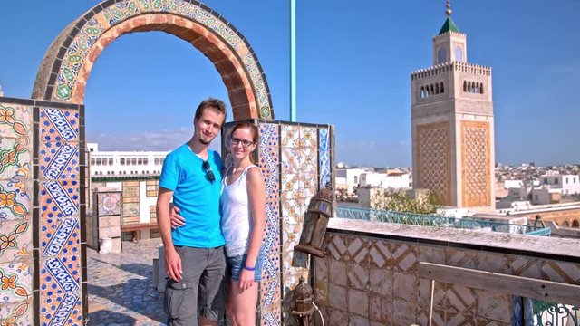 Couple posing with Tunis town in background
