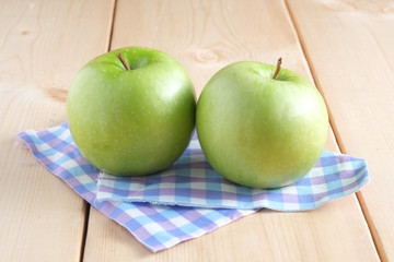 Green apple on a wooden table