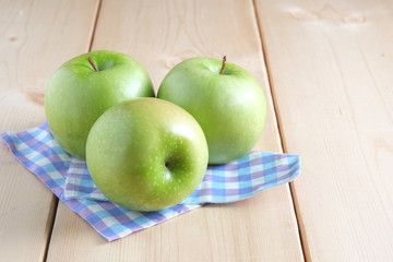 Green apple on a wooden table