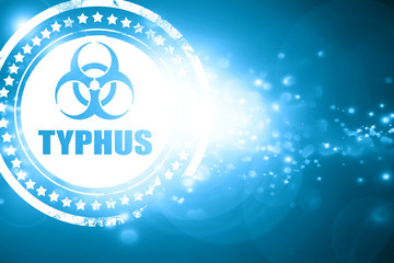 Blue stamp on a glittering background: Typhus concept background