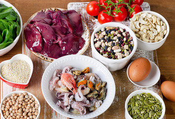 Foods high in Iron, including eggs, nuts, spinach, beans, seafoo