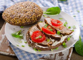 Grain bread sandwich with turkey and tomatoes. Healthy eating.