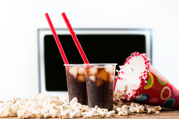 Popcorn and cola drink on wooden background