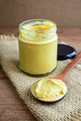 Mustard sauce on rustic wooden table