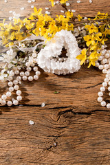 flowers, heart and perls on wooden background