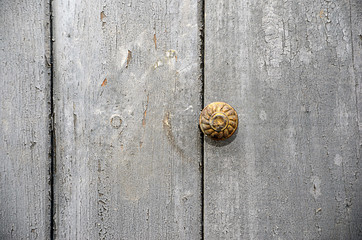 old door with copper button handle detail photography