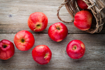 Ripe red apples on wooden background.