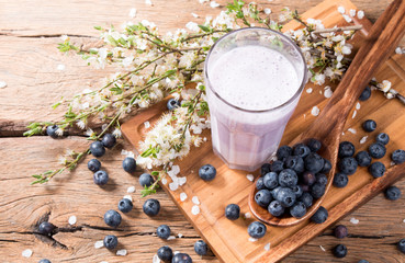 Fresh milk, blueberry drink on wooden table, assorted protein cocktail with fresh fruits.