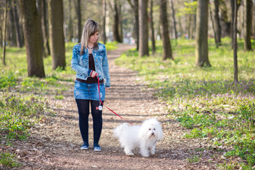 Beauty woman and her dog in the park