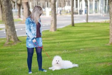 Beauty woman and her dog in the park