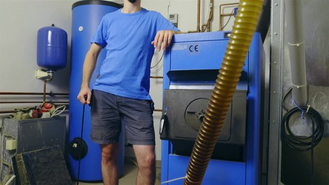 Man stand next to complicated water boiler