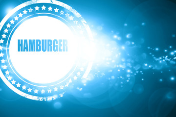 Blue stamp on a glittering background: Delicious hamburger sign