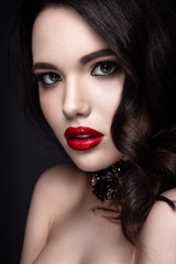 Beautiful woman portrait. Young lady posing close up on black background. Glamour make up, red...