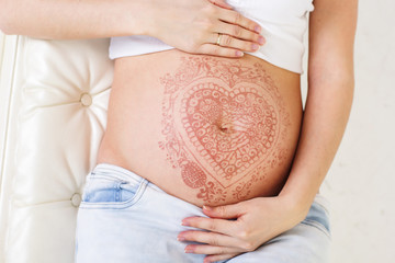 Pregnant belly with mehendi henna tattoo 