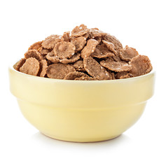 Bowl with grain cereal flakes on the white background.